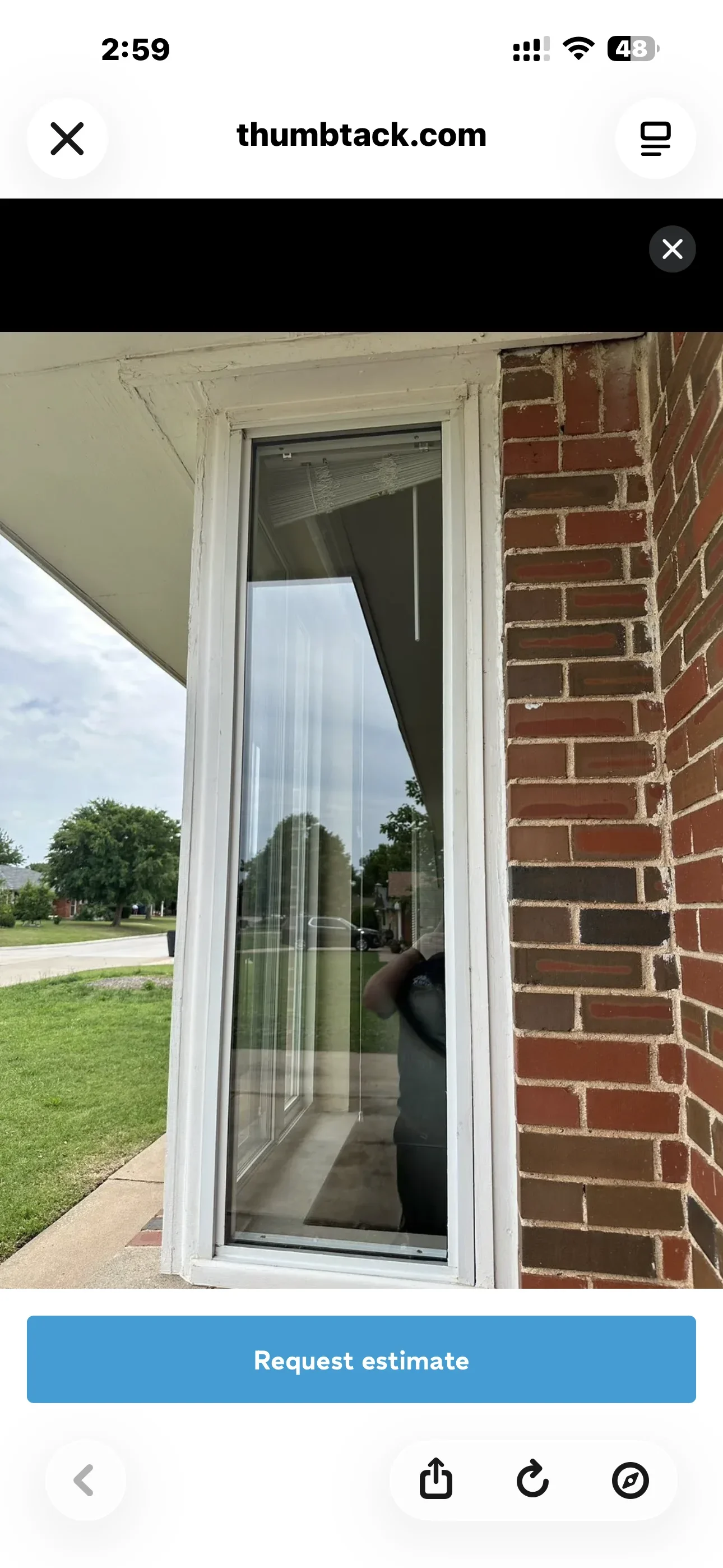 White vinyl sliding glass door with dark tinted glass installed on brick home exterior